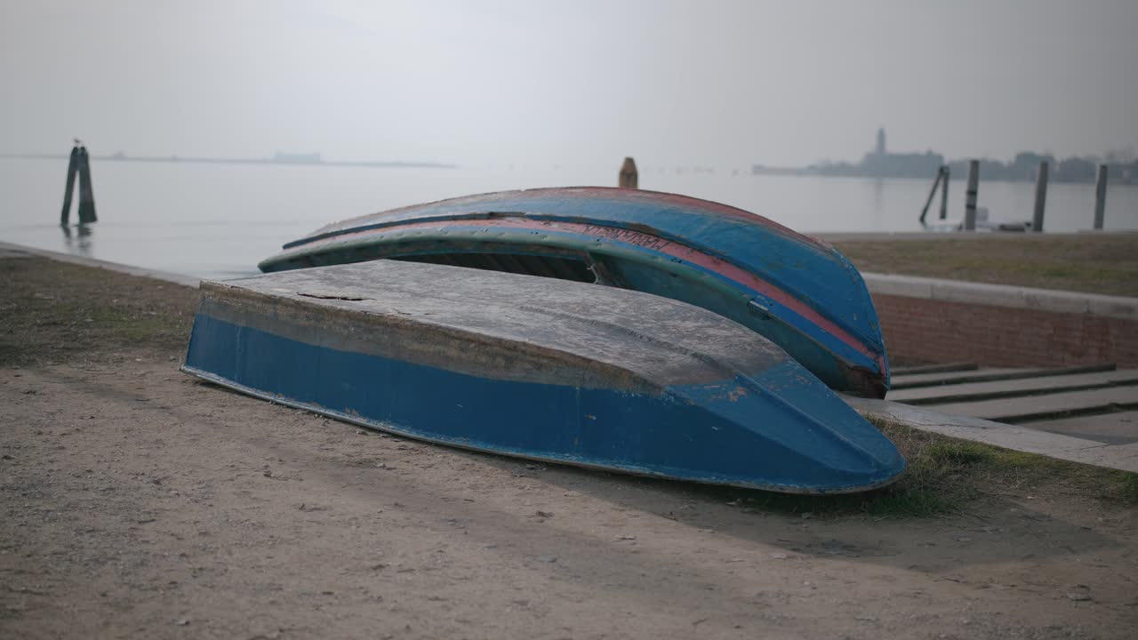 barcos retirados en tierra en la niebla de la isla de burano, venecia, italia