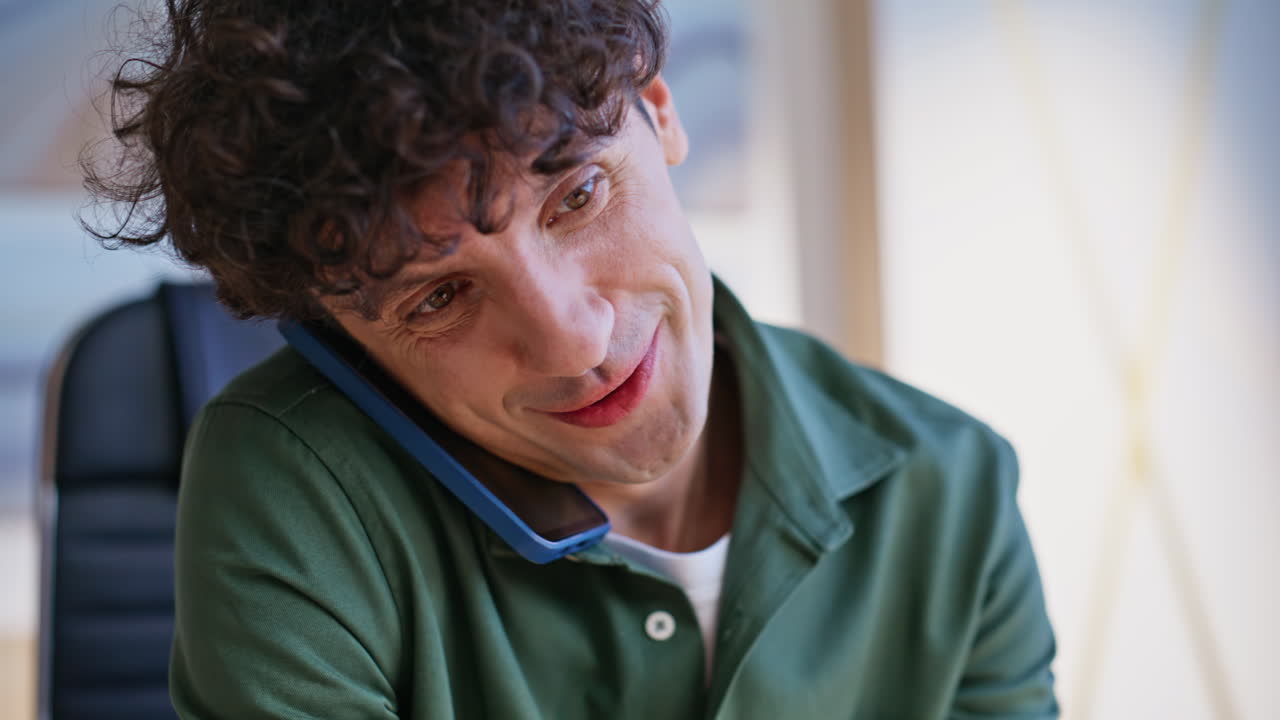 Office manager typing report at laptop while talking cellphone in office closeup