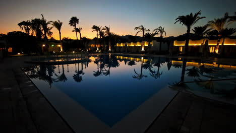 experience a tranquil sunset by the pool, with palm trees and resort ambiance in egypt.