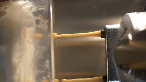 espresso pouring into a glass