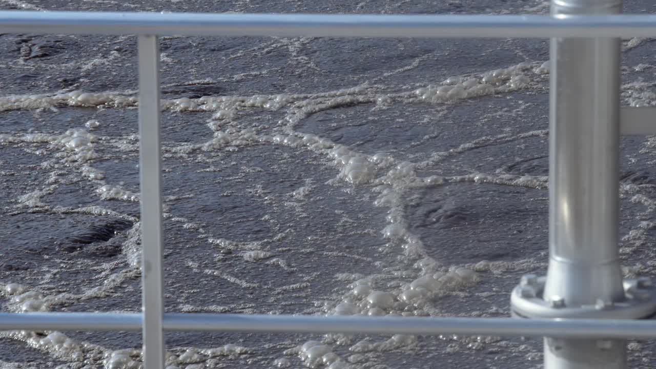 Close-up of an aeration basin with flowing water during wastewater treatment, symbolizing purification and renewal, dominated by blue and gray hues.