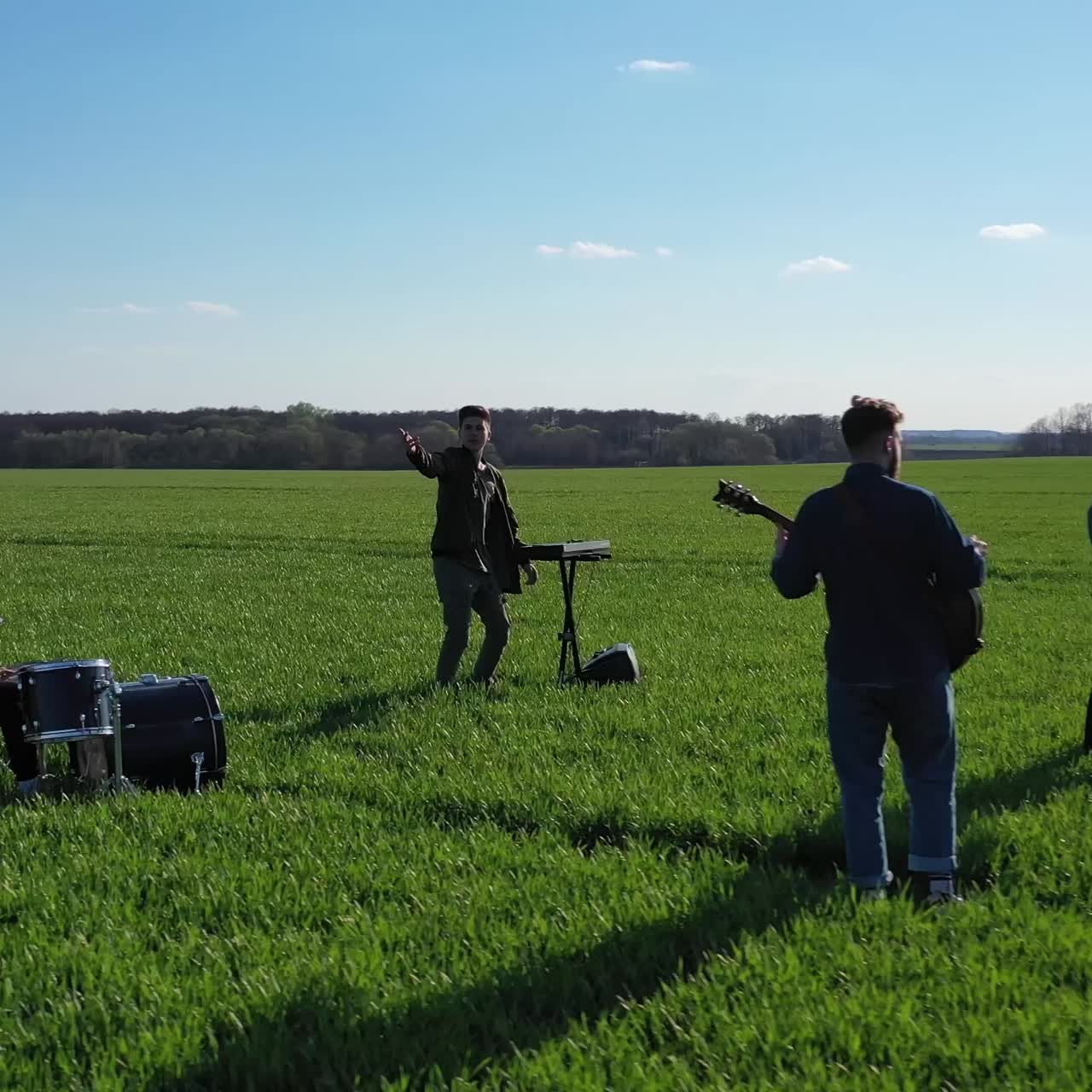 Musical Group Playing Outdoors. Young band playing concert on field