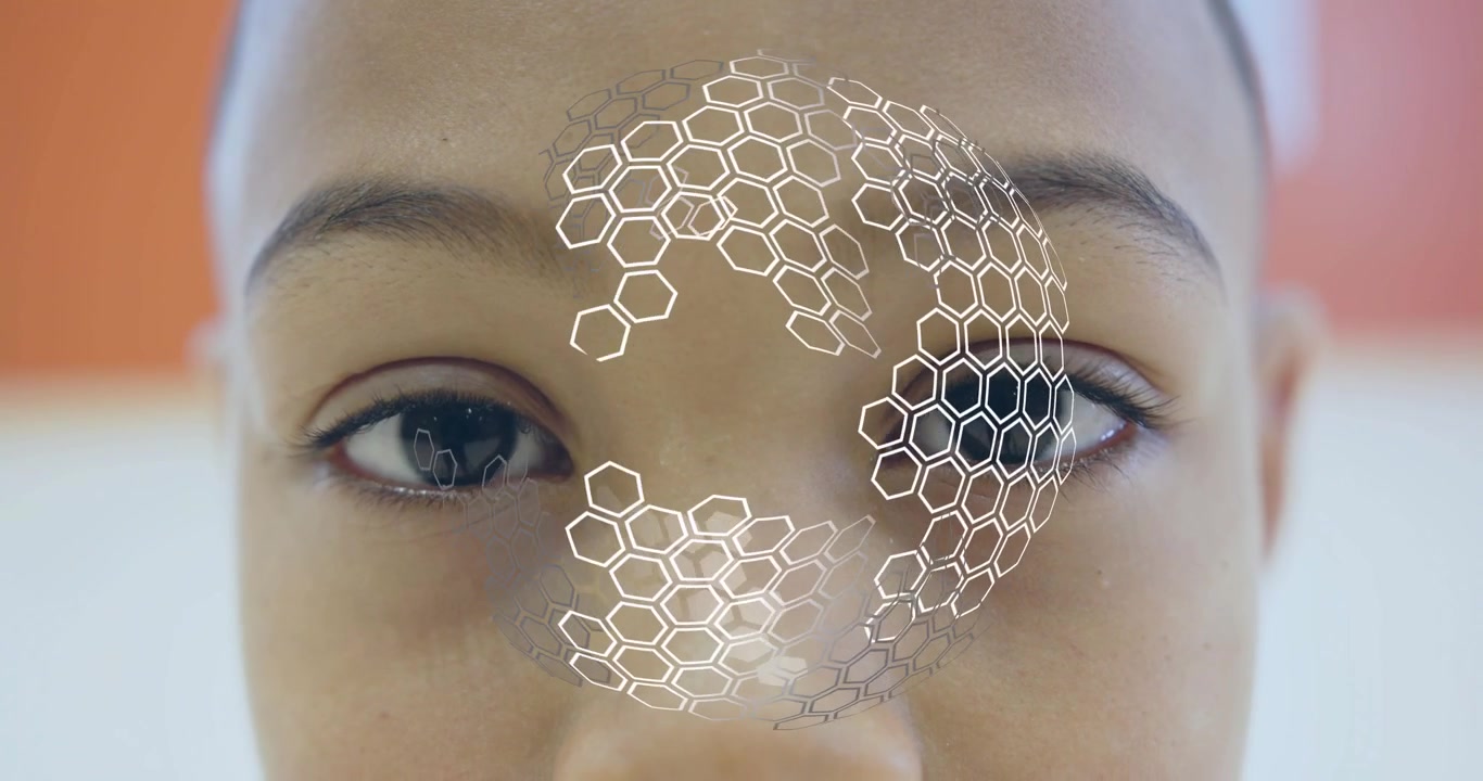 Child staring into camera initiating facial scan rotating hex grid mapping face for recognition