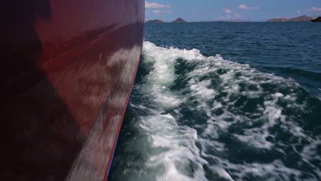 foamy splashing waves of a sailing wooden boat on seascape of bali, indonesia. - pov