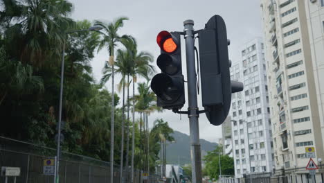 Signal-Transition:-Close-Up-Shot-of-Orange-to-Red-Traffic-Light-in-Hong-Kong