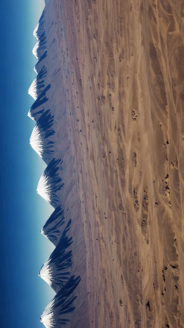 Aerial View of Snowy Mountain Range in Desert