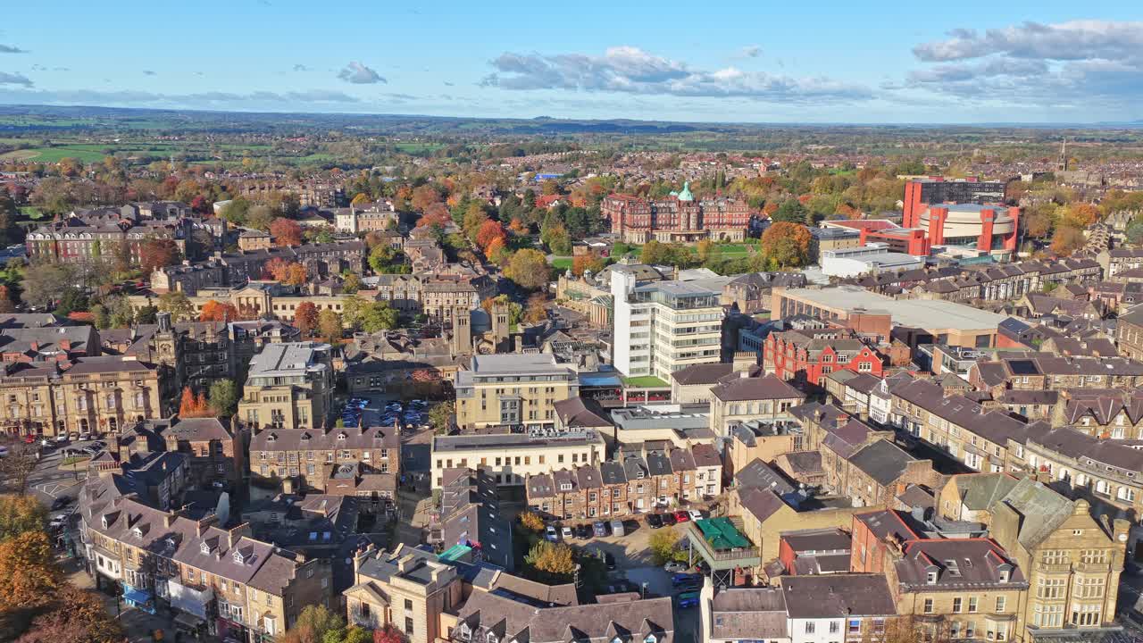 Aerial panorama of Harrogate reveals the Convention Centre, stone Victorian streets, hospital blocks, and a horizon blending town and rural landscapes