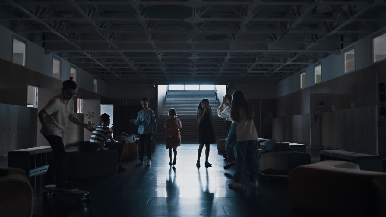 Silhouette pretten girl rushing hall going to staircase. Pupil leaving school.