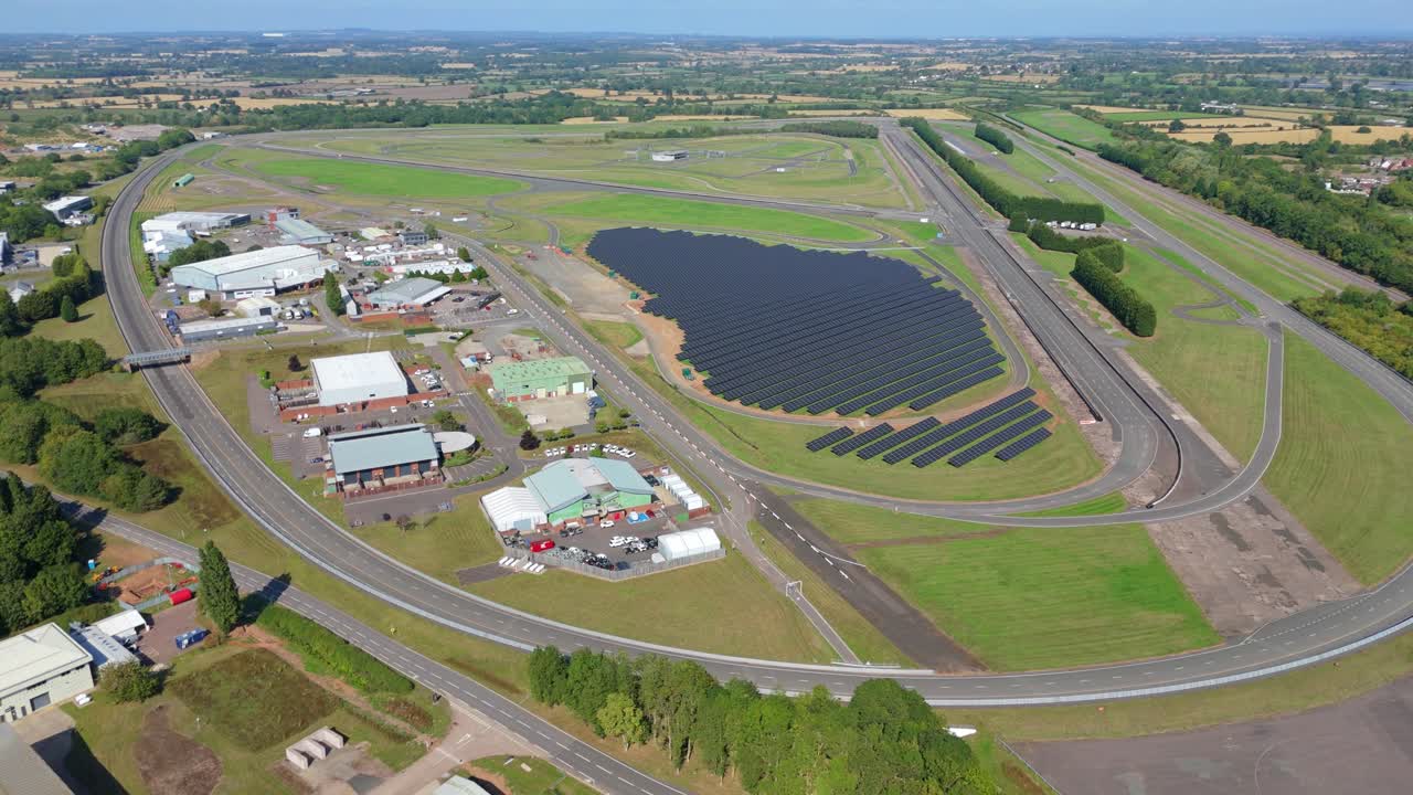 Aerial drone view of motor industry race track and testing ground with solar power panels photovoltaic renewable energy generation England UK