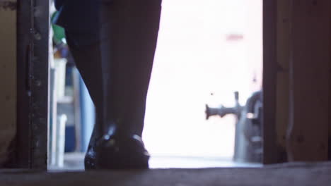 focus pull - a farmers rubber boots walk towards camera