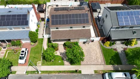 Aerial-Birds-Eye-shot-of-modern-Rooftop-Solar-Panels-On-Home-In-American-Neighborhood