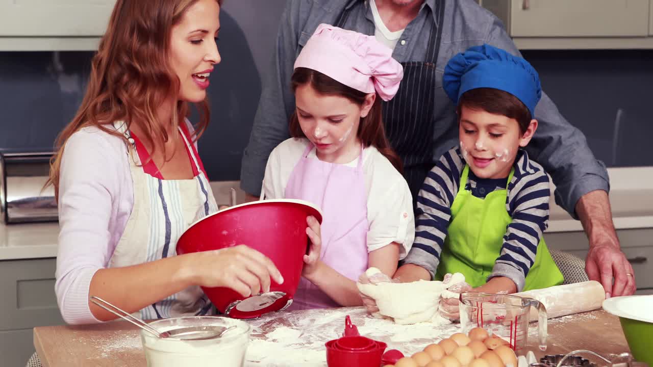 Happy family cooking biscuits together