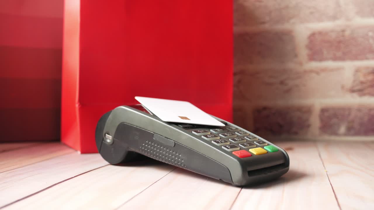 Credit Card Payment at Point of Sale with Red Bag
