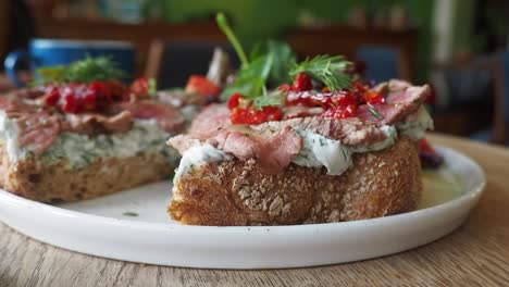 gourmet open-faced roast beef sandwich with sun-dried tomatoes