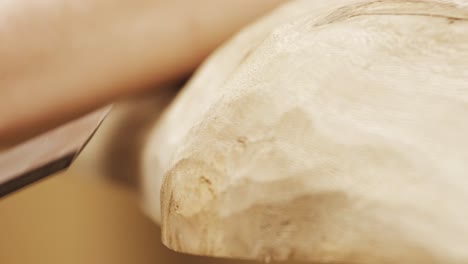 Close-shot-of-a-chisel-on-a-wooden-table