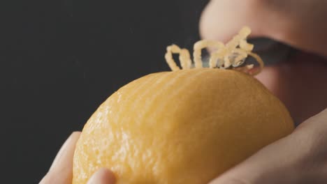 scrapping lemon zest in slow motion