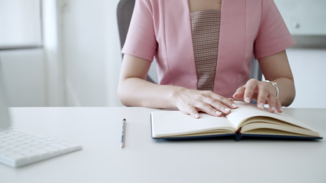 A moment of reflection in a modern workspace with coffee and a notebook.