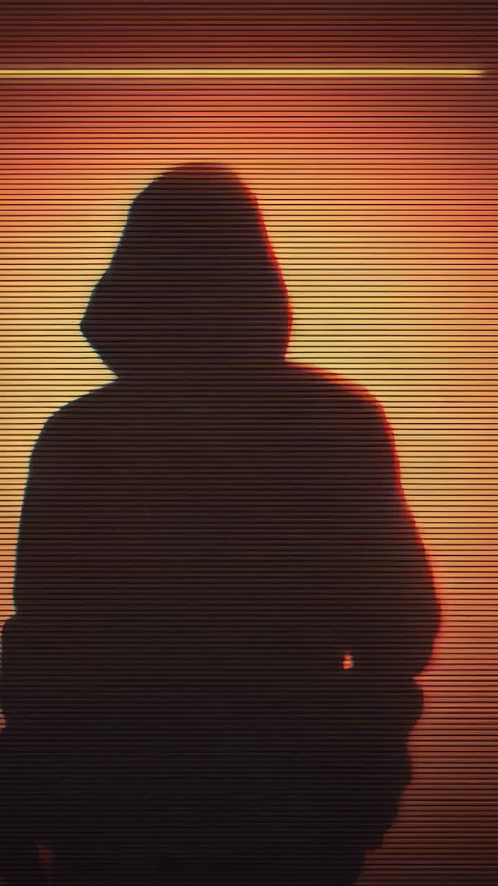 Vertical video: Swaying person in hoodie shifting torso in studio, showing anonymity, neon scanline