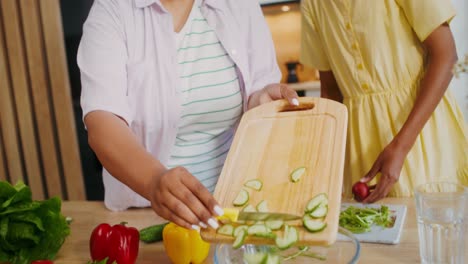 mother and daughter preparing a salad