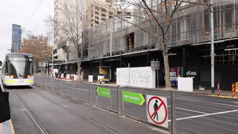 tram moves along city street in melbourne