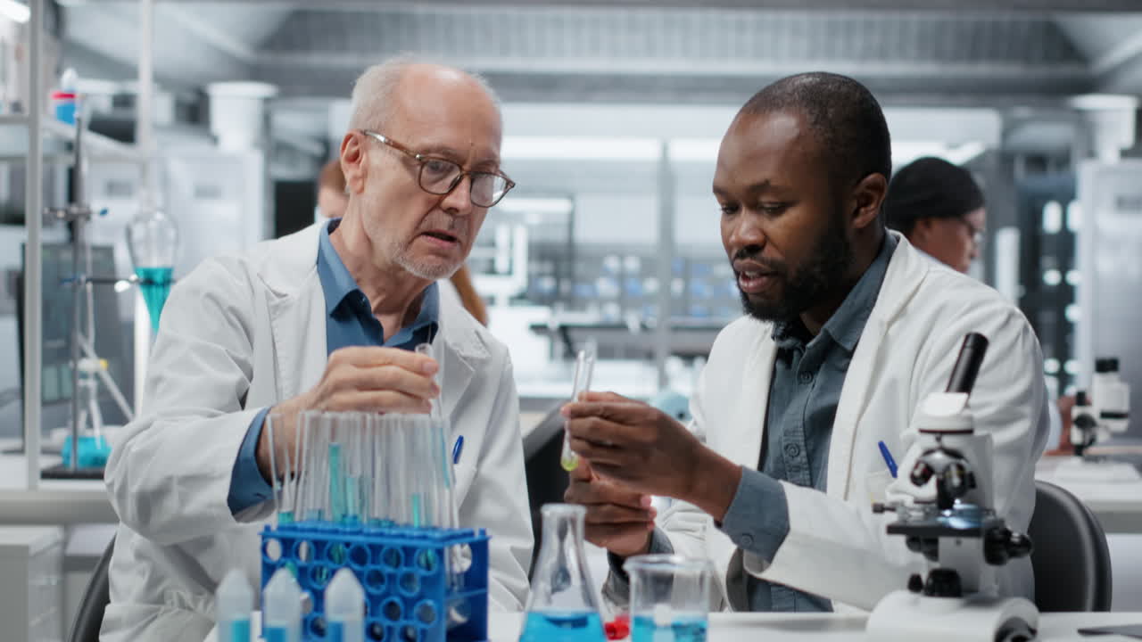 Teamworking molecular biologists in lab evaluate blue compound solution