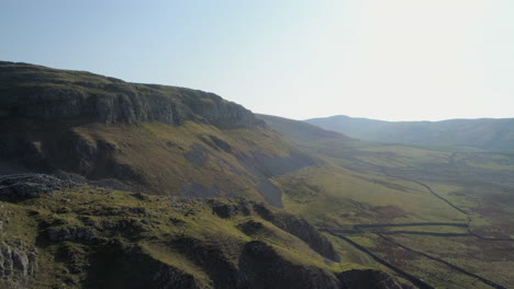 Aerial-Drone-Shot-Flying-over-Warrendale-Knots-Yorkshire-Dales-Countryside-Grass-and-Rocky-Hills-with-Farm-Sheep-and-Dry-Stone-Walls-on-Sunny-Summer-Day-UK