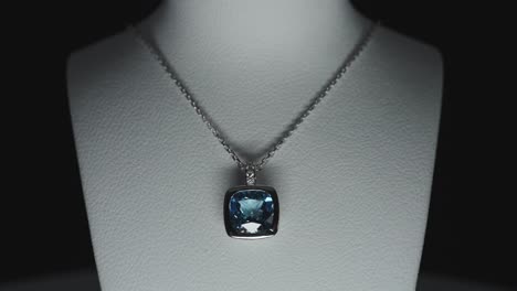 blue gemstone on a necklace on a bust