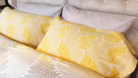 yellow and white fern pattern bedding on a bed