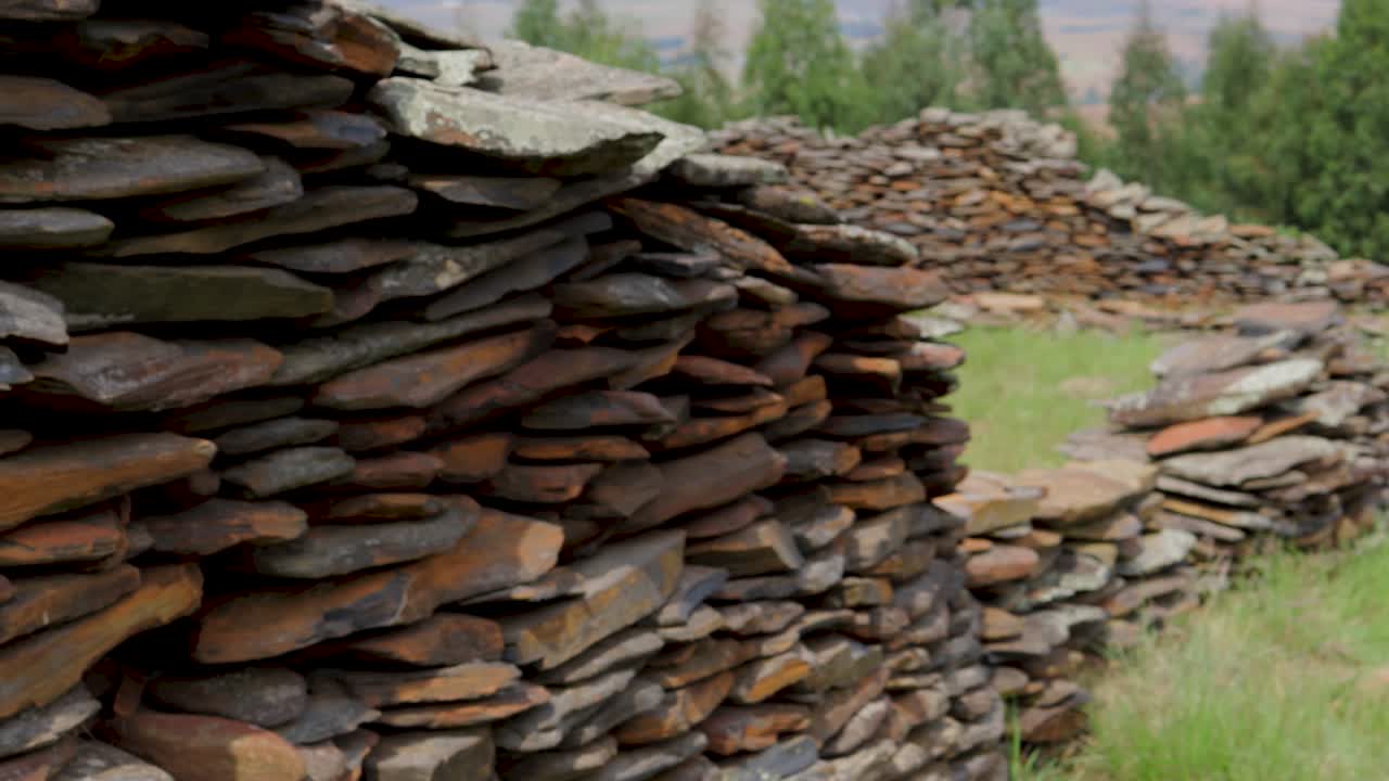 Close up to an old stone wall that is part of an old ruin