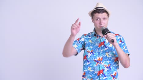 young handsome tourist man with microphone