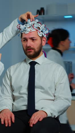 man undergoing eeg brain scan in a medical laboratory