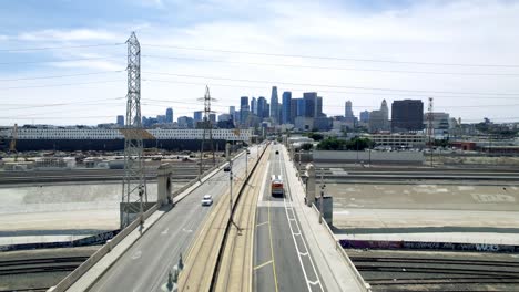 Aerial-view-of-1st-Street-Bridge-in-downtown-Los-Angeles-on-sunny-day-tracking-city-bus