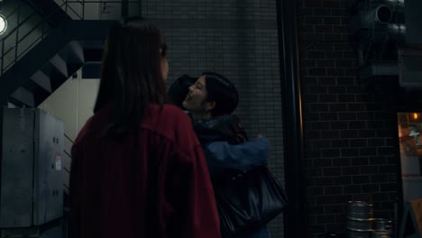 two people having conversation at night in a city street