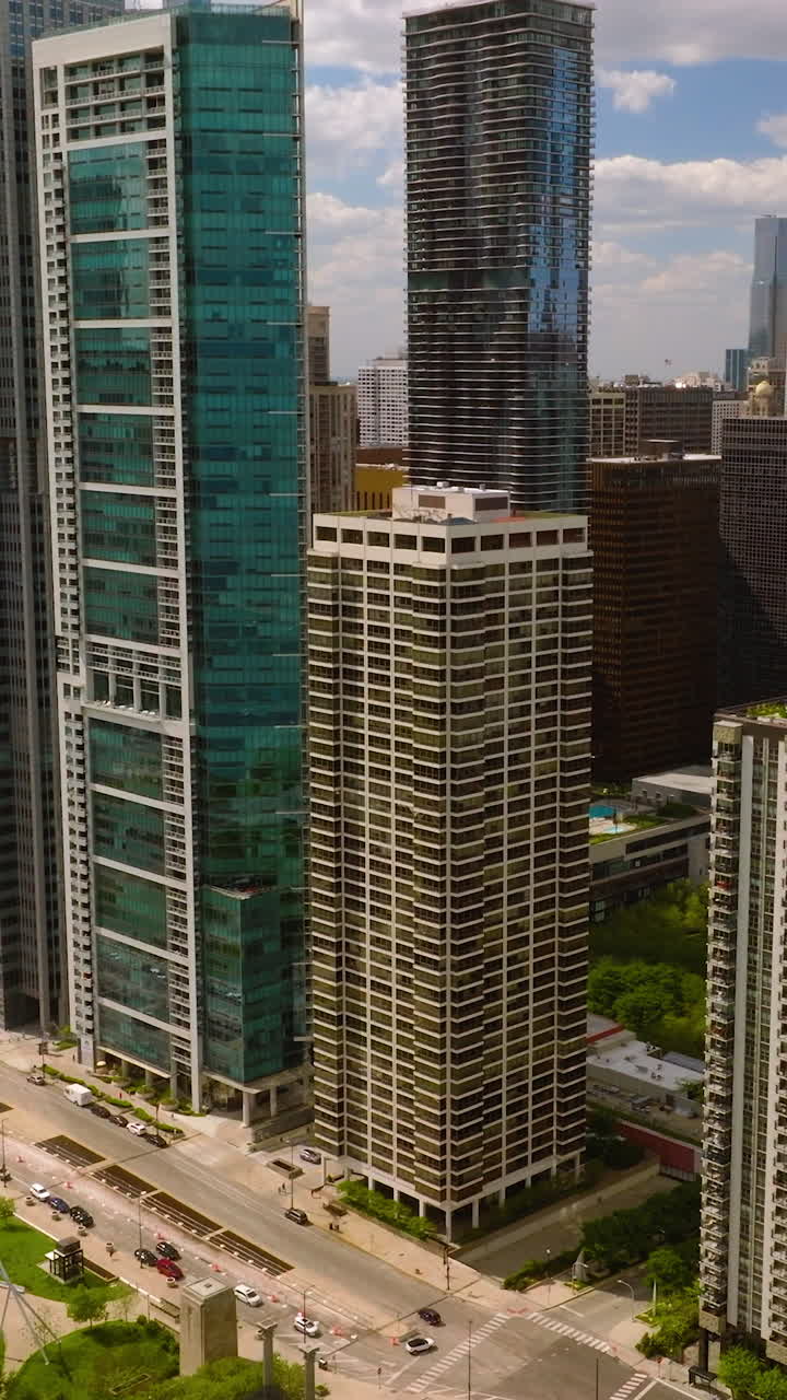 Dazzling architecture of downtown Chicago. Beautiful Millennium Park on bright sunny day. Aerial perspective. Vertical video