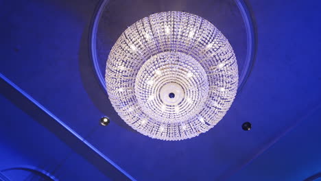 large crystal chandelier on the ceiling of a banquet hall