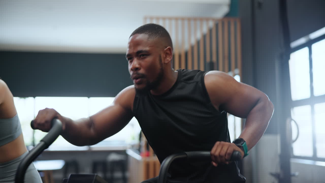 Man Working Out on Rowing Machine at Gym