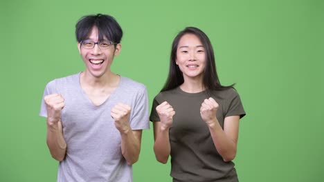 young asian couple looking excited