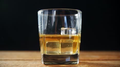 ice cubes falling in whisky 4k