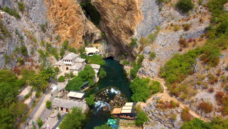 village and mosque on rocky cliffs - blagaj tekija on buna river in bosnia and herzegovina