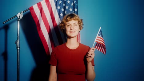 woman holding american flag in studio