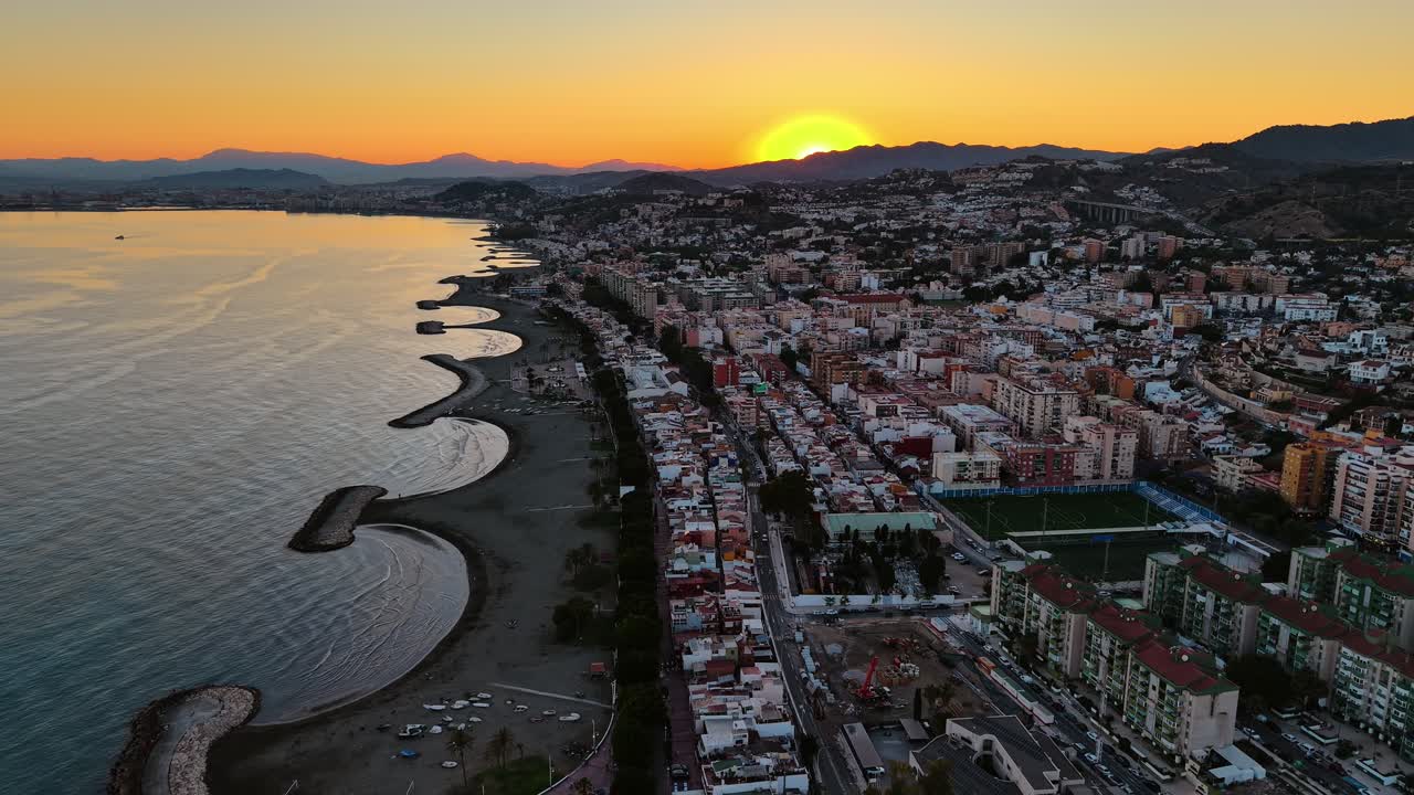 Sunset over Malaga with coastal view and vibrant cityscape
