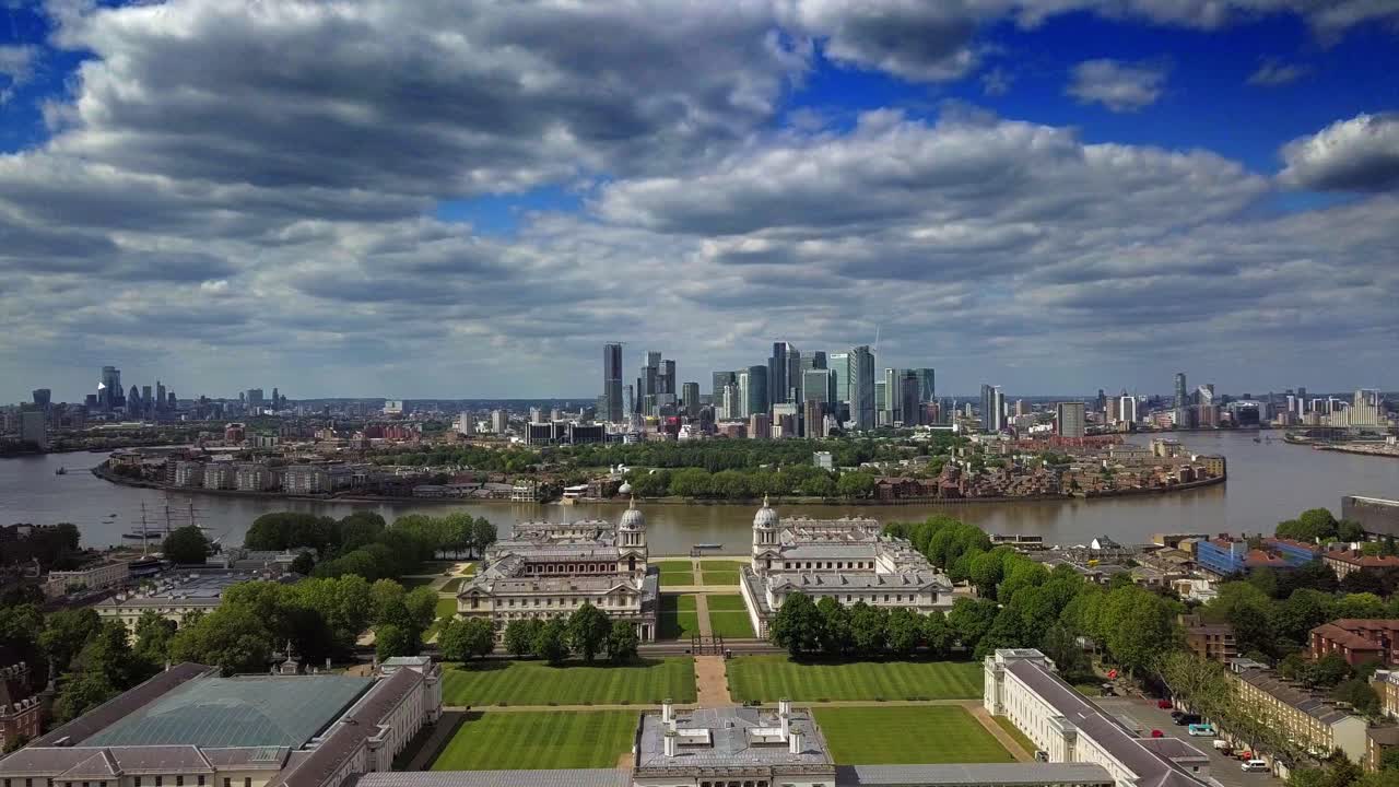Outstanding aerial view of Isle of Dogs and financial district Canary Wharf in London United Kingdom in a scattered cloudy day under blue sky from Greenwich University and Observatory