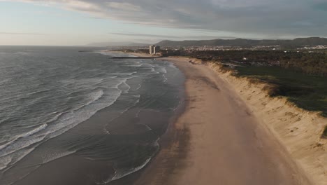 wide-aerial-view-of-Ofir-Beach-in-Esposende,-Portugal,-with-sand-dunes-and-ocean-waves