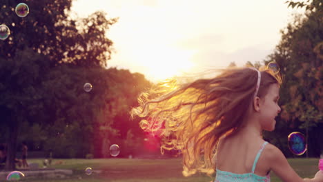 little girl playing with bubbles in the