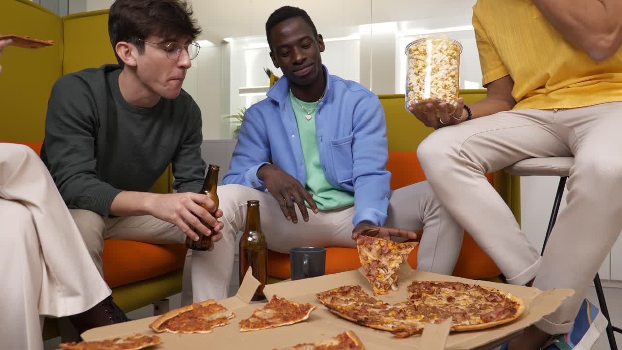 Friends enjoying pizza and popcorn during casual hangout