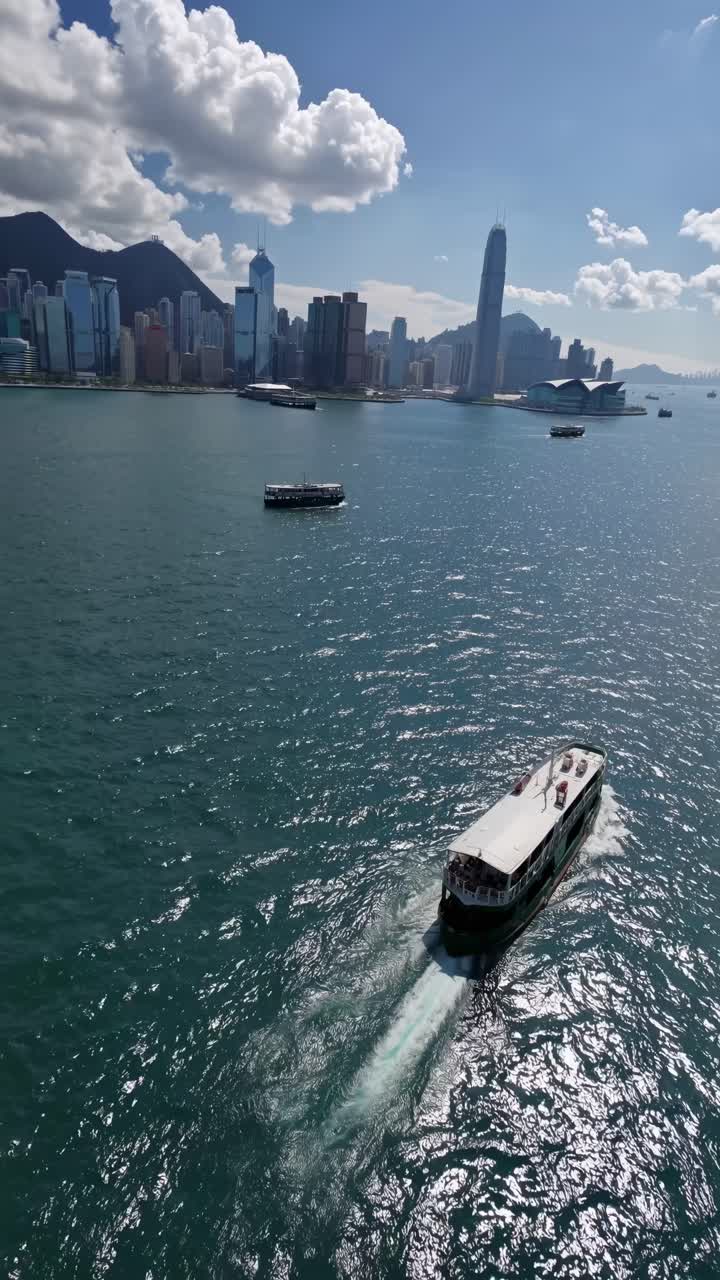 Aerial video captures a ferry gliding through a vibrant harbor, with a ...