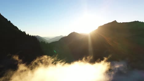 aerial view of sunset sunlight above clouds and mountain peaks