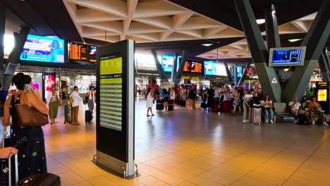 people checking schedules at turin station