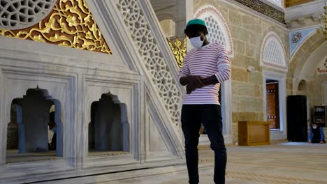 black man praying in mosque