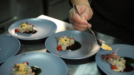 chef plating delicious shrimp appetizers